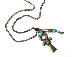 "A mystical necklace featuring a large Egyptian ankh pendant with a scarab beetle decoration, an ancient symbol of the resurrection of life, accented with painted touches of lustrous violet and turquoise! A little violet Swarovski crystal rhinestone sparkles from its back and turquoise blue magnesite beads dangle alongside the unique pendant! A faux turquoise stone sits at the top of the ankh pendant as yet another design element. The luck-bringing pendant dangles from a sturdy antiqued gold cha Mystical Necklace, Large Necklace, Bohemian Accessories, Egyptian Jewelry, Colourful Necklace, Unique Pendant, Beaded Dangles, Leather Necklace, Bohemian Jewelry