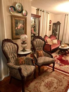 a living room filled with lots of furniture next to a wall covered in pictures and paintings