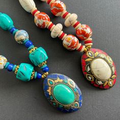 This artisan-crafted chunky pendant necklace is the perfect accessory for all jewellery lovers. It features hand-painted  beads, and an oval pendant with a polished large stone that makes for a statement look.  The on-trend long necklace will accentuate any plain outfit, be it workwear or casual everyday wear, or even evening ensembles. The perfect accessory for you or gift idea for her on her birthday, as a Christmas present or on other important occasions, such as Anniversaries. Dimensions: - Length: 58cm approx. (end-to-end excluding pendant) - Pendant: 5cm x 6.5cm approx. Colours available: Turquoise, White (main colours) Handcrafted Chunky Pendant Necklace, Chunky Pendant, Painted Beads, Hand Painted Beads, Plain Outfits, Large Stone, Necklace Turquoise, Oval Pendant, Beaded Necklaces