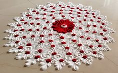 a red and white doily is on the floor