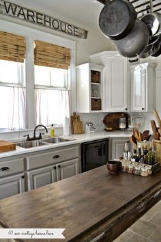 a kitchen filled with lots of appliances and cooking utensils on top of a wooden counter