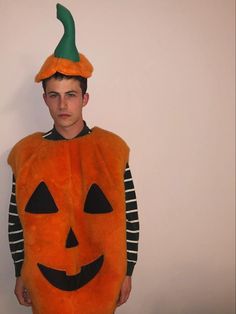 a young man in a pumpkin costume