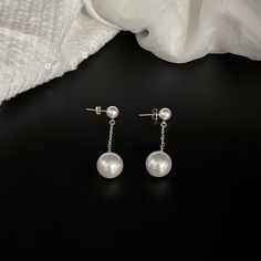 "Classic small to large White Swarovski crystal pearl post dangle earrings.  Beautiful shimmering Swarovski crystal pearls with a smaller one at the post and a larger crystal pearl suspended from bright sterling silver cable chain to create these stunning dangle earrings for a casual, formal, classic or minimalist style. Perfect for weddings or a tuxedo affair.  This listing is for one (1) pair of double pearl drop earrings.  There are two post pearl sizes available, 6mm or 8mm. The pearl suspended at the bottom of the chain measures 12mm. Please choose the size pearl at the post for the earlobe prior to check out.  If you have any questions please message me directly. LENGTH:  1 3/4 inches CREATED WITH: - Swarovski 6mm or 8mm crystal pearls (choose size prior to checkout) - Swarovski 12 m Minimalist Wedding Earrings, Pearl Earrings Drop, Drop Pearl Earrings, Earrings Classic, Classy Casual, Earrings Minimalist, Earrings Drop, Swarovski Pearls, Large Crystals