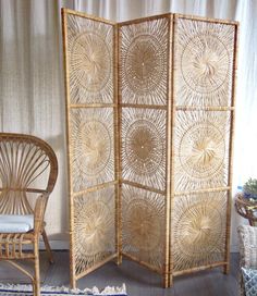 a room divider made out of rattan and wicker with chairs around it