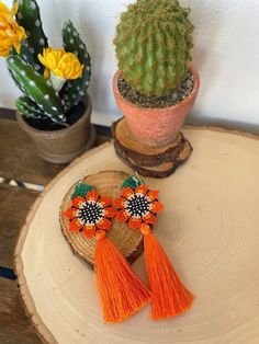 These beautiful earrings are handmade of chaquira beads. Woven bead by bead to create stunning styles and designs, the long tassle gives it a very vibrant look to create the perfect accessory for you. - Lightweight - 4" length - Fish hook earring Bohemian Orange Tassel Earrings, Traditional Beaded Tassel Dangle Earrings, Traditional Beaded Dangle Earrings With Tassels, Traditional Beaded Tassel Earrings, Traditional Adjustable Beaded Tassel Earrings, Handmade Artisan Tassel Earrings, Traditional Beaded Earrings With Tassels, Traditional Beaded Tassel Earrings As Gift, Traditional Beaded Tassel Earrings For Gift