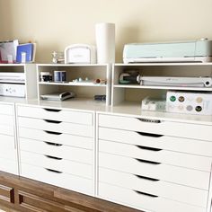 a white dresser with many drawers and items on it