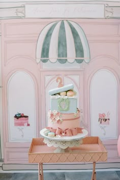 a pink and blue cake sitting on top of a table