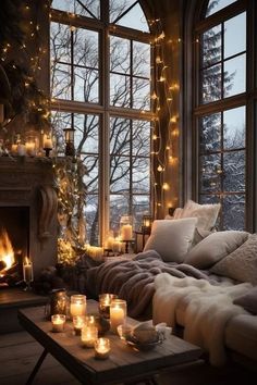 a living room filled with lots of candles next to a window covered in blankets and blankets