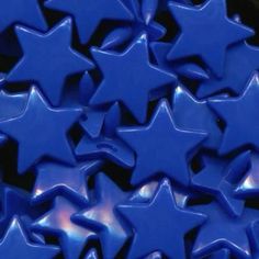 many blue stars are arranged together on a black surface