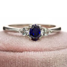 a close up of a ring with a blue stone