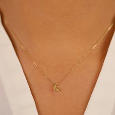 Luna Keep your dreams close with our dainty Mini Plain Gold Moon Pendant Necklace. This celestial charm features a solid 14k gold moon pendant with a touch of thickness for a dimensional look. The minimal design and polished gold finish create a timeless and versatile piece that complements any outfit. Crafted from high-quality 14k gold (available in yellow, white, or rose gold), this necklace offers long-lasting durability and a touch of luxury. - Handmade- Solid Gold- Size of Moon: 7 x 5 mm- The thickness of the Moon: 2 mm All pieces come beautifully boxed in suede pouches you can always use when traveling! Small Gold Pendant Designs, Minimal Pendant Necklace, Minimal Jewelry Necklace, Minimal Gold Jewelry, Small Pendant Necklace, Gold Chain Pendant, Minimal Pendant, Pendant Minimalist, Minimal Gold