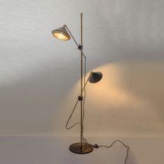 a lamp that is on top of a table next to a white wall and floor