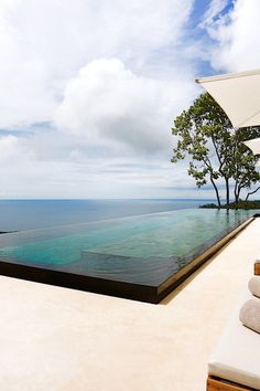 an outdoor swimming pool overlooking the ocean