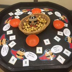 a black tray topped with lots of different types of toys and items on top of it