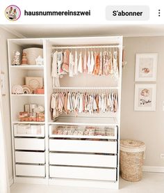 a baby's closet with lots of clothes hanging on the shelves and drawers in it