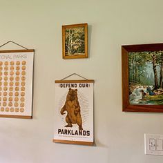 there are several posters on the wall in this room, including one with a bear