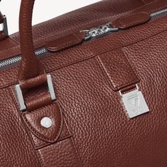 Luxury Cognac Weekender Bag For Everyday, Designer Business Duffle Bag With Leather Trim, Designer Brown Duffle Bag For Everyday, Designer Duffle Bag With Leather Trim For Business, Designer Everyday Brown Duffle Bag, Classic Business Travel Bag In Textured Leather, Luxury Cognac Duffle Bag For Everyday, Luxury Duffle Bag For Weekend Trips, Luxury Everyday Cognac Duffle Bag