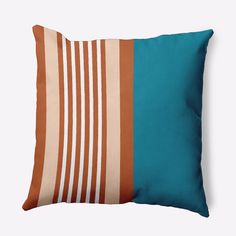 a blue and orange striped pillow sitting on top of a white wall