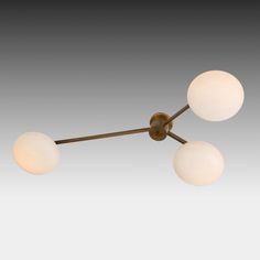 three light ceiling fixture in an old - fashioned style with white glass balls on the arms