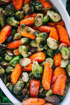 roasted carrots and brussel sprouts in a white dish