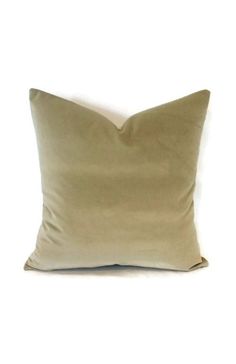 a beige pillow on a white background