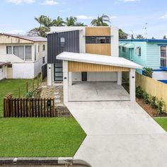 an image of a house that is in the middle of a yard with grass and trees