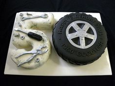 there is a cake made to look like a tire and some tools on the plate