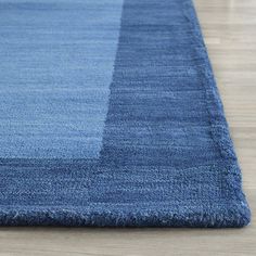 a blue area rug on a wooden floor