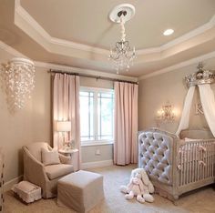 a baby's room with a chandelier and crib