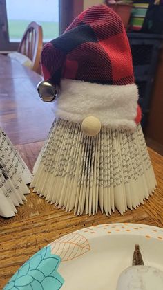 an open book hat sitting on top of a table next to a plate and fork