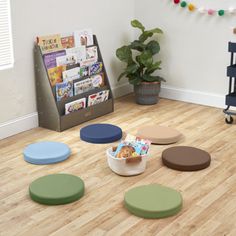 a child's playroom with toys and books on the floor