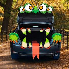 the back end of a car with an image of a monster on it's trunk