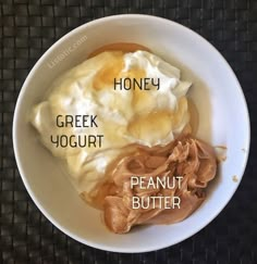 a bowl filled with yogurt, peanut butter and honey