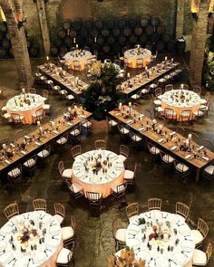 an overhead view of tables and chairs with wine barrels in the background