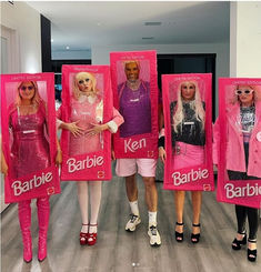 four barbie dolls are standing in front of each other holding barbies on their heads