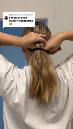 a woman is holding her hair back with one hand