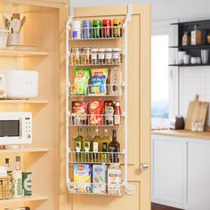 an organized pantry in a kitchen next to a microwave