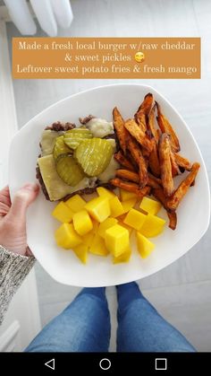 a person holding a plate with food on it