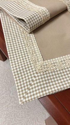 the table is covered with beige and white checkered fabric, along with matching placemats