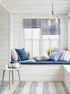 a window seat with pillows on it in a room