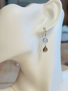 The Dusk Drop earrings are gold vermeil over sterling ear wires with a faceted cube of Mystic Blue Quartz and a teardrop Smokey Topaz stone. These dainty earrings measure approximately 1.25 inches long. Because these are faceted stones, they truly catch the light and have a striking sparkle in the sun. Natural stones may vary slightly in color. Shown in photos with the Eternity Choker-Gold Handcrafted in the USA. They will arrive wrapped, perfect for gift giving! Gold Faceted 14k Gold-filled Earrings, Gold Briolette Crystal Earrings With Ear Wire, 14k Gold Filled Faceted Drop Earrings, Dainty Faceted Briolette Earrings, Dainty Briolette Faceted Earrings, Gold Wire-wrapped Briolette Teardrop Earrings, Gold Wire Wrapped Briolette Teardrop Earrings, Gold Briolette Earrings Nickel Free, 14k Gold Filled Faceted Earrings For Gift