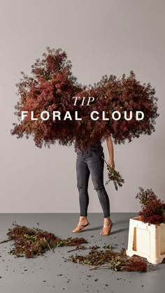 a man is standing in front of a pile of dead flowers with the words tip floral cloud above him