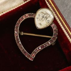 This a lovely 15ct gold pendant from the mid-Georgian era. The pendant is in a classic witches heart style but features a rare addition, a cartouche displaying the letters FH crafted in wonderful hair work.  The witches heart brooch was given to a loved one to help keep away the evil spirits, the brooch was also pinned to the swaddling blankets of babies for the same reason.  Condition: Used (Very Good) Weight: 2.1 grams Dimensions: 25mm x 20mm x 3mm (not including pin) Tested As: 15ct Gold Peri Victorian Brooches With Locket Pendant, Victorian Locket Pendant Brooches, Antique Hallmarked Pendant Brooches, Antique Pendant Brooch Hallmarked, Antique Pendant Brooches Hallmarked, Antique Baroque Brooches With 17 Jewels, Victorian Brooch For Memorial, Victorian Brooch Jewelry For Memorial, Victorian Brooch For Memorials