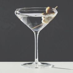 a martini glass with an olive in it