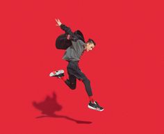 a man is jumping in the air with his skateboard and shadow on the ground