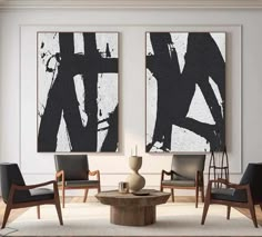 two black and white paintings hang on the wall above a coffee table in an elegant living room