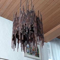 a chandelier hanging from a wooden ceiling