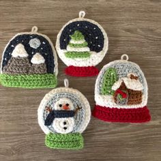 three crocheted christmas ornaments with snowman and sleigh in the background