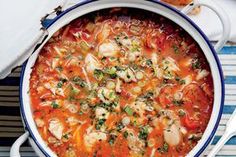 a bowl of soup on a table with bread