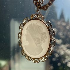 In purely vintage condition, this pressed Czech Glass Cameo is secured in cabochon style surrounded with a wire gold tone frame. This vintage cameo brings out the heart in all of us!  Item: pendant necklace - - - Identification: unmarked - - - Style: Cameo - - - Approximate Date / Era: 1940's - - - Material: pressed glass stone, brass wire frame and chain (the pendant could be gold vermeil, but untested).  - - - Colour(s): white glass, gold tone - - - Condition: the structure is good. The glass has fatigued over time and the backside is crazed. I believe the bust was once surrounded in dark paint, which has flaked off over time.   Dimensions (sizes approximate): medium sized pendant - - - Length of chain: 16 1/2g: 420" (mm) - - - Pendant height: 1 3/4" (45mm) - - - Pendant width: 1 3/8" (3 Cameo Pendant Necklace, Vintage Pendant Necklace, Vintage Cameo, Cameo Necklace, Paper Jewelry, Cameo Pendant, Wire Frame, Pressed Glass, White Glass